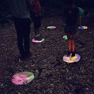 Kids playing with aural borealis at night